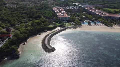 Aerial orbit right around wave breaker at Geger Beach Stockbeeldmateriaal 329077572