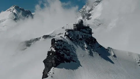 Aerial orbit right to establish backlit sphinx observatory in Jungfraujoch Stock Footage 279125394