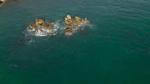 Aerial Orbit of Rocky Sea Stacks With Crashing Waves in Turquoise Water Portugal Stock Footage 325831758