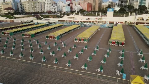 Aerial orbit shot of empty yellow beach spa and resort at sunrise morning. Vidéo 152342060