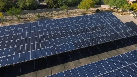 Aerial orbit of a solar panel covered parking lot Видео 129160346