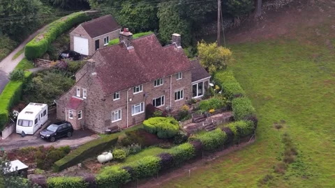 Aerial Orbit of Stone Cottage in English Countryside Stock Footage 314476620