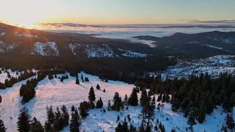 Aerial orbit of sunlit winter mountain field with distant Tatra peaks Stock Footage 336446226