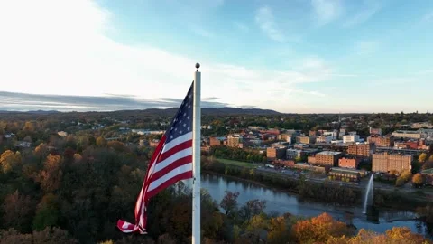 Aerial orbit of USA Flag waving in breeze. American pride. Cinematic Stock Footage 165587285