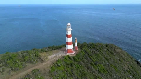 Aerial orbit view around Punta Zaragoza lighthouse on a cliff of the seashore Stock Footage 225311737