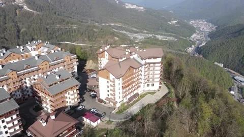 Aerial orbit view of the Olympic Village buildings in the mountains Stock Footage 337544932