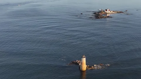 Aerial orbit of Whaleback Lighthouse in golden morning light, Kittery, Maine Stock Footage 346526706