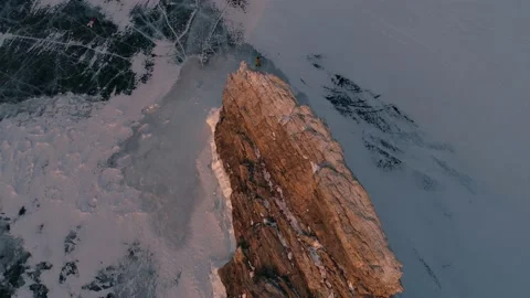 Aerial orbital high angle shot over the rocky island in lake Baikal. Winter Stock-Footage 163156589