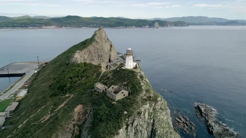 Aerial orbital view of an old lighthouse on the cliff on pacific coast Stock Footage 168658150