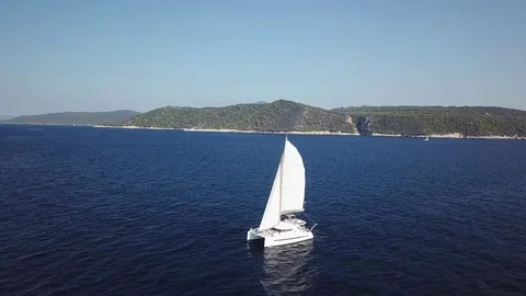 Aerial orbital view side to front Catamaran Sailboat sailing in full sails Stock Footage 96374763