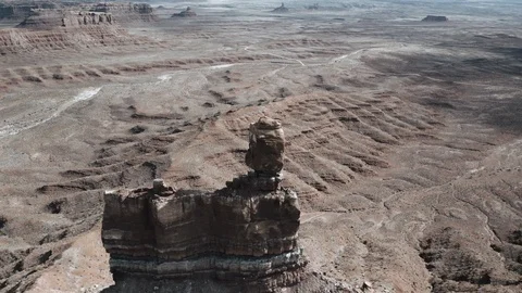 Aerial orbiting beautiful stone formation in red desert valley Stock Footage 124870085