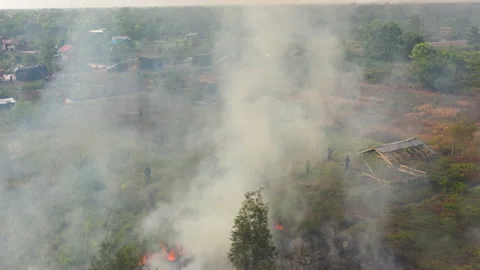 Aerial Orbiting Fire with Fire Fighters Behind the Haze, Indonesia Stock Footage 142507283
