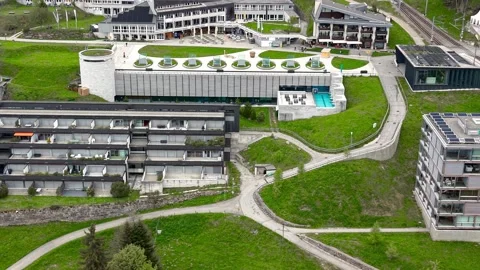 Aerial orbiting shot of modern architecture buildings at Rigi Kaltbad Video stock 340486361
