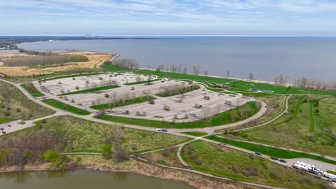 Aerial orbiting view of an empty lakeshore parking lot in Michigan Stock-Footage 339263521