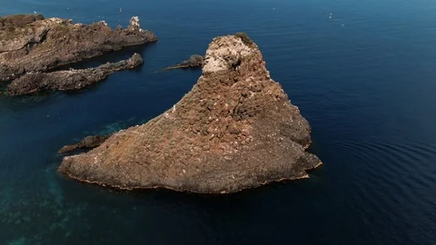 Aerial orbiting view of the faraglioni in Acitrezza, Sicily Stock Footage 110803229