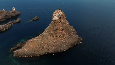 Aerial orbiting view of the faraglioni in Acitrezza, Sicily Stock Footage 111860480