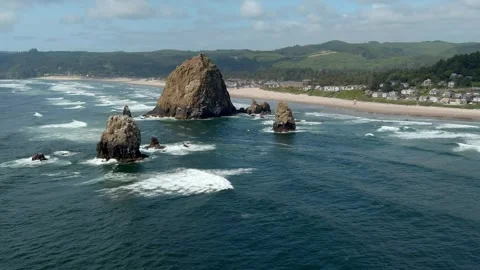Aerial orbiting view of Haystack Rock off the coast of Cannon Beach, Oregon. Stock Footage 311205306