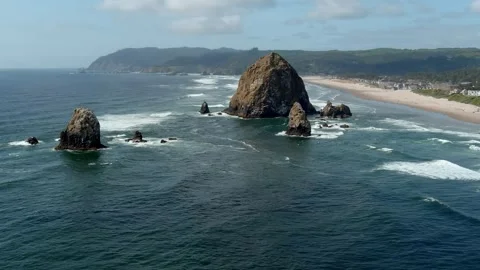 Aerial orbiting view of Haystack Rock off the coast of Cannon Beach, Oregon. Stock Footage 311205308