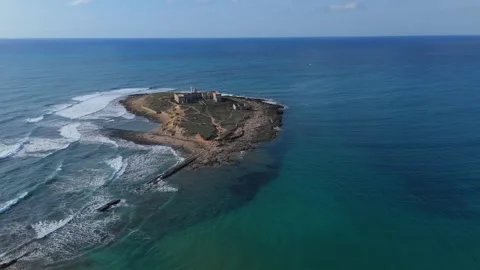 Aerial orbiting view of the small island Isola delle Correnti in Sicily Stock Footage 299341708