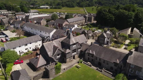 Aerial orbiting view of St John the Baptist church in Penmachno, Wales Video stock 336754992