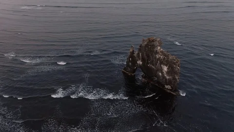 Aerial orbiting view of a stone on the sea in Hvitserkur, North Iceland Stock Footage 116184728