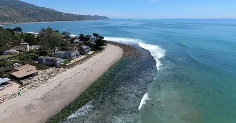 Aerial over beach at Rincon Point, California Stock Footage 72972503