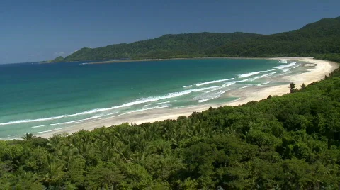 Aerial over beautiful tropic beach with forest in the background Stock Footage