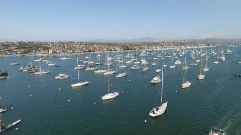 Aerial over boat coasting through marina on a sunny day Video stock 157232357