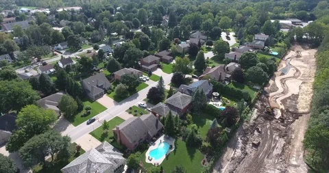 Aerial Over Construction Site Between Houses And Green Forest Stock Footage 95346799