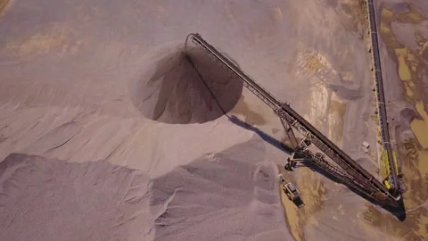 Aerial over a conveyor dumping aggregate in a pile Stock Footage 132780761