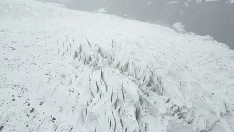 Aerial over the expansive, deeply crevassed white ice fields of Passu Cones Stock Footage 342007553