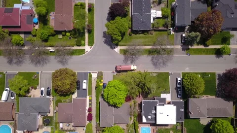 Aerial over a garbage truck in a residential neighborhood. Stock Footage