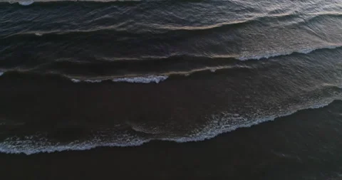 Aerial Over Gentle White Cap Waves Coming As Series Of Lines In Evening Light Stock Footage 189246691
