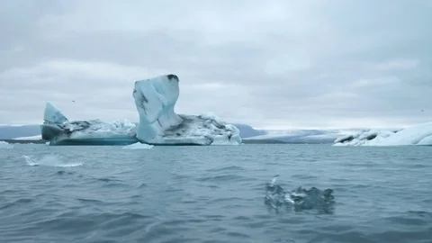 Aerial over icebergs floating in Jokulsarlon Lagoon by the southern coast of Stock Footage