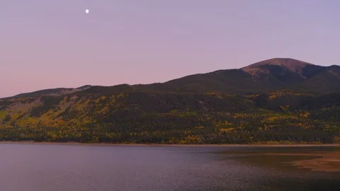 Aerial - Over lake along mountains with moon in the sky Stock Footage 95350053