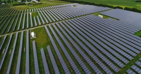 Aerial Over Large Solar Panel Farm And Their Colorful Line Pattern Rural Design Stock Footage 196093842