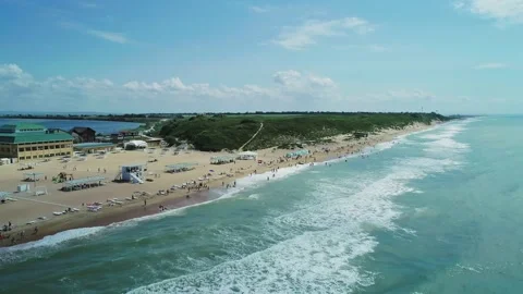 Aerial over the long sandy spit with a beach and azure water on a sunny summer Видео 219772855