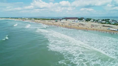 Aerial over the long sandy spit with a beach and azure water on a summer day Video stock 219773334