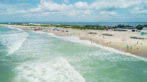 Aerial over the long sandy spit with a beach and azure water on a summer day Stock Footage 219773360