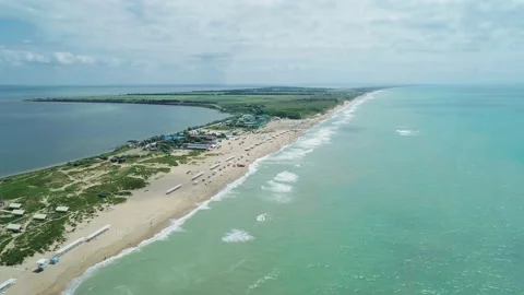 Aerial over the long sandy spit with a beach and azure water on a sunny summer Video stock 219773702