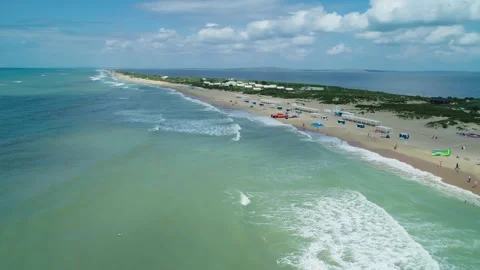 Aerial over the long sandy spit with a beach and azure water on a sunny summer Video stock 219773986