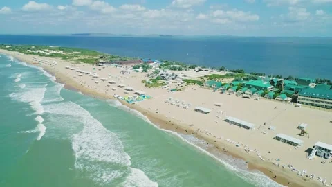Aerial over the long sandy spit with a beach and azure water on a sunny summer Video stock 219774695