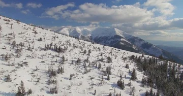 Aerial over mountains in winter. Nice panoroma with snow and beautiful clouds. Stock Footage 85883257