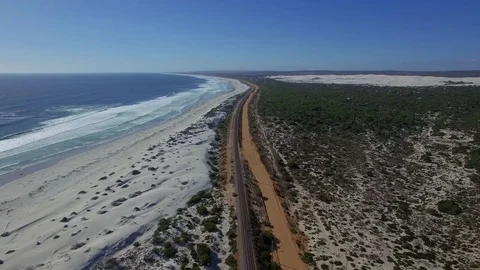 Aerial over Moving Train on Beach Coast Stock Footage 79747446