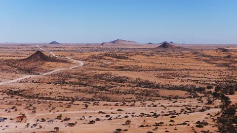 Aerial over Namibia desert plain toward inselbergs near Spitzkoppe Stock Footage 341422805