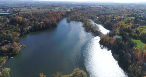 Aerial Over Nice Forest Pond Reservoir With Sun Reflecting On Water Video stock 186952607