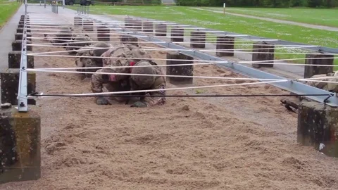 An aerial over an obstacle course during army basic training. Stock Footage 79418083