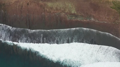 Aerial over ocean reef break waves and beach in Uluwatu Bali 4K Drone Footage Stock Footage 103222364