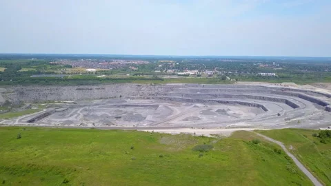 Aerial over an open quarry pit on a sunny day Stock Footage 135485423