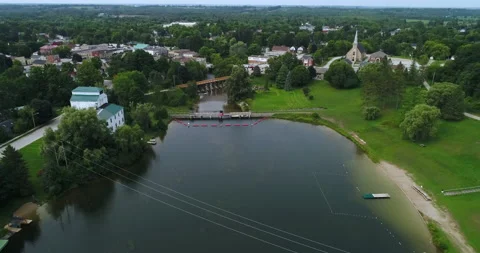 Aerial Over River In Park By Small Rural Town And Landscape On A Overcast Day Stock Footage 200705446